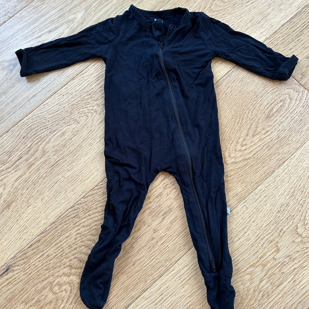 Black solid color Kyte Baby zip footie